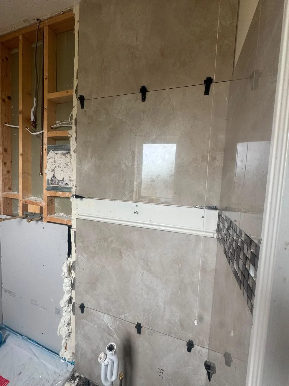 Neatly finished bathroom wall and floor tiling in Dublin